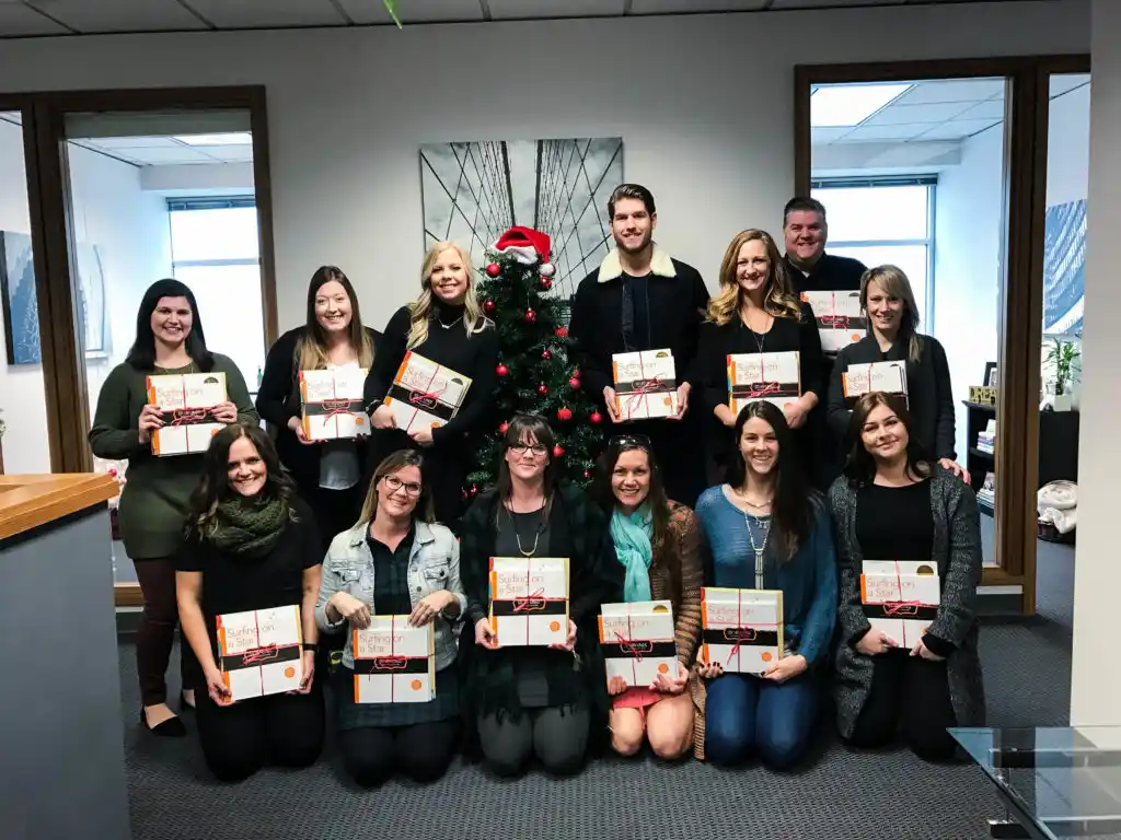 Lamb Real Estate Team Book Donations to The Christmas House