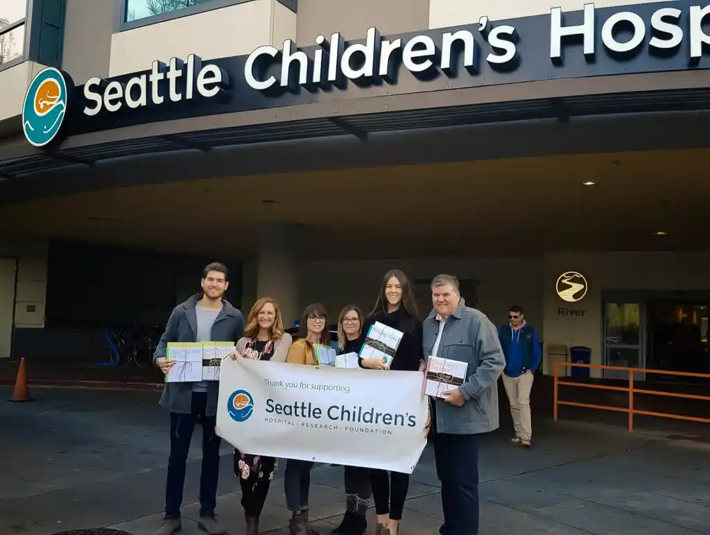 Lamb Real Estate Delivering Books to Seattle Children's Hospital